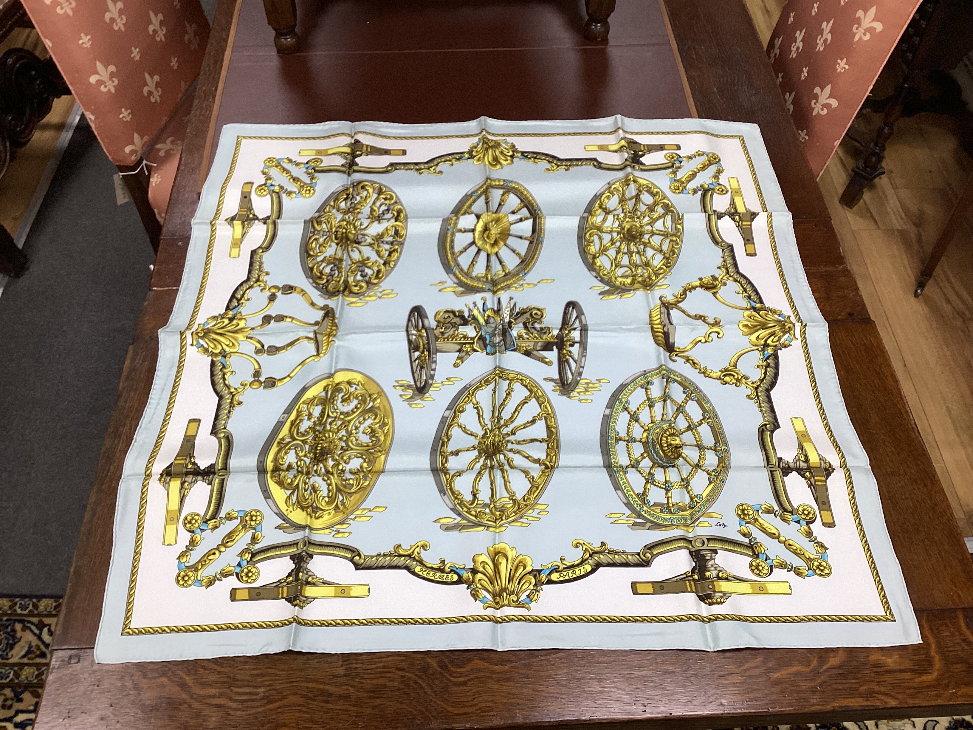 Four vintage Hermes silk scarves including two retailed by Harrods comprising Cuivreries, Roues de Canon, Napoleon and Puzzle